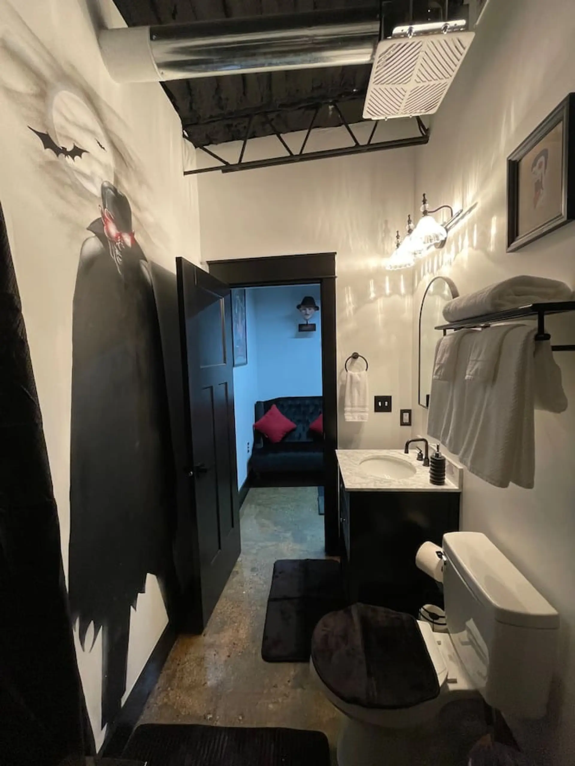 Dracula themed master bathroom with vampire mural, bats, and gothic decor